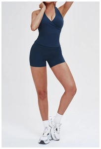 Detail of navy blue ribbed yoga set featuring a halter V-neck top and high waist shorts