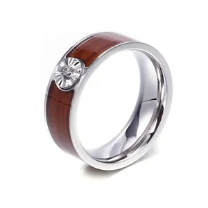 Polished stainless steel ring with wood inlay, floral centerpiece and cubic zirconia