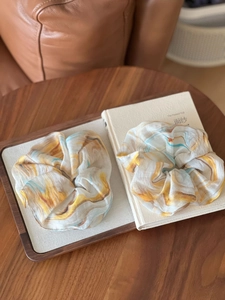 Artistic oil painting pattern silk scrunchies on a wooden tray with a warm vintage style