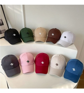 Multiple colors of embroidery baseball caps with MW logo displayed on white stands