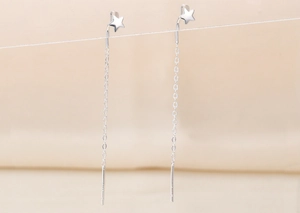 Detail of silver S925 star and moon tassel threader earrings with fine dangling chain