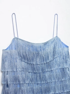 Detail shot of light blue tiered fringe camisole top with thin spaghetti straps