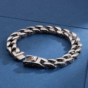 Close-up of retro silver stainless steel bracelet with intricate tribal engravings