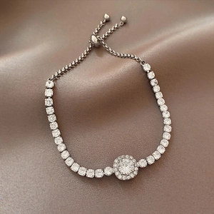 Elegant silver adjustable pull-string bracelet with halo zircon stone on brown satin cloth