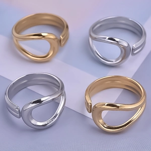 Detailed view of irregular streamlined adjustable rings in gold and silver finishes
