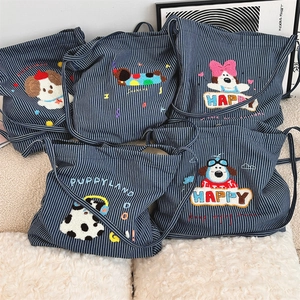 Close-up of striped canvas bag with cute cartoon puppy embroidery and Happy lettering