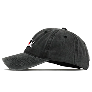 Detailed embroidery of a cute ghost on dark grey washed denim baseball cap texture