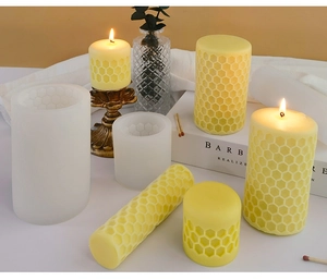 Macro view of honeycomb textured silicone candle molds and finished beeswax pillars