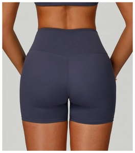 Detail view of high-waisted gym shorts featuring V-shaped booty contouring and compression fabric