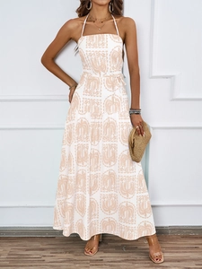 Detail of tropical palm print fabric and tiered skirt on halter neck maxi dress
