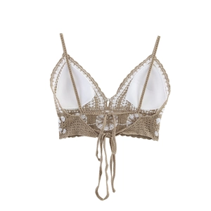 Detailed back view of light khaki crochet halter top with lace trim and tie closure