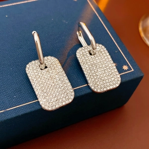 Macro shot of silver square hoop earrings with sparkling crystal pavé on jewelry box