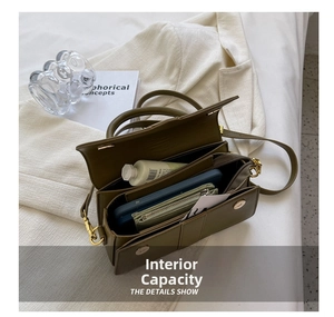 Internal view of olive green flap bag showing phone and wallet storage capacity