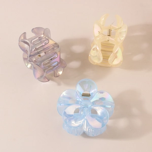 Three translucent colorful floral hair claws in purple, yellow and blue for women's styling