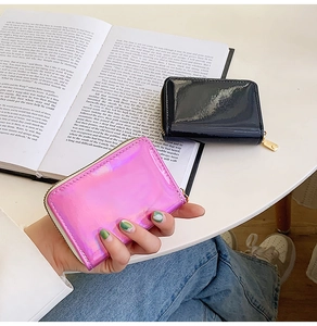 Detail of laser finish card holders in pink and black with smooth gold zippers