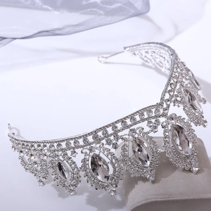 Detailed close-up of sparkling silver bridal tiara with marquise crystals on velvet