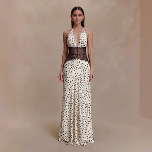 Close-up of elegant polka dot maxi dress with black lace waist and backless design