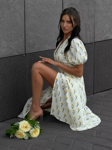 Detail of white cotton floral dress with yellow tulip print and retro puff sleeves