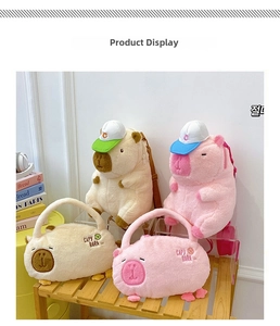 Detail of plush capybara backpacks in pink and beige with cute knitted hats on shelf