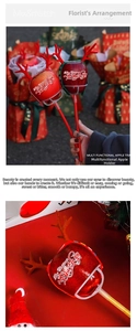 Detail of red Christmas apple bouquet base with festive reindeer antlers and support rod