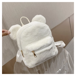 Detail showing white plush backpack with cute animal ears and soft faux fur texture