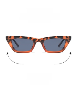 Macro detail of retro tortoise shell cat-eye sunglasses with narrow frame and dark lenses