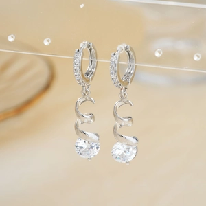 Sparkling zircon drop earrings with spiral silver metal and round cut gemstone