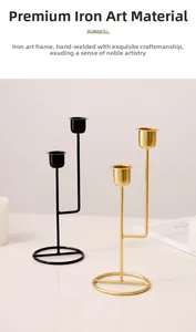 Detail of minimalist iron candle holder with gold and black cups on marble surface