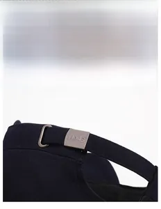 Detail of navy blue cotton cap featuring an adjustable metal buckle with Sport engraving