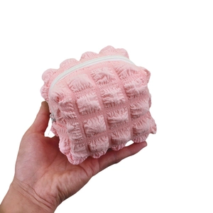 Pink puffer bubble textured pouch with white zipper closure for cosmetics and small items