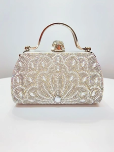 Detailed view of silver rhinestones and pearls on the sparkling luxury evening bag