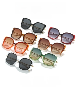 Detail showing seven fashionable cat-eye sunglasses with unique twisted metal temples