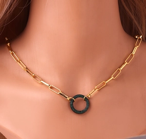 Gold-plated chain necklace with a green zircon pendant shown on a model's neck