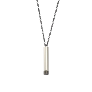 Macro shot of mirror-polished stainless steel cylindrical nested pendant necklace
