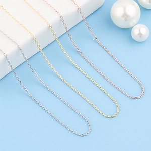 Stainless steel cable chain necklaces in silver, gold, and rose gold on blue background