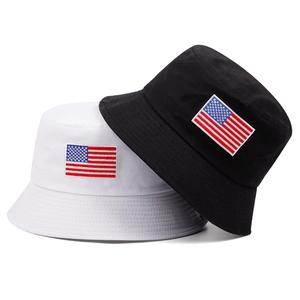 Detail shot of black and white bucket hats with American flag embroidery and neat stitching