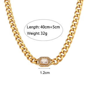 Golden stainless steel Cuban necklace with cubic zirconia pendant on white background
