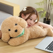 Close-up of a plush brown teddy bear with a green scarf in a cozy lifestyle setting