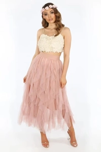 Detail view of tiered pink mesh tulle skirt paired with a white 3D floral camisole top