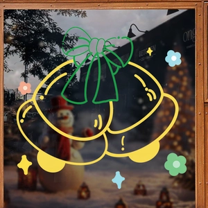 Christmas window stickers with festive yellow bells and bows on a cozy glass door background