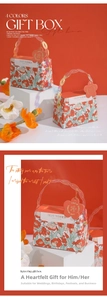 Detail of red floral wedding candy gift box with ring handle and Best Wishes tag