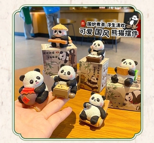 Detail of 6 cute panda resin figurines in various poses with Chinese style gift boxes