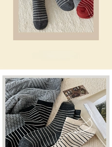 Detail of wool crew socks with striped patterns and warm knit texture in neutral colors