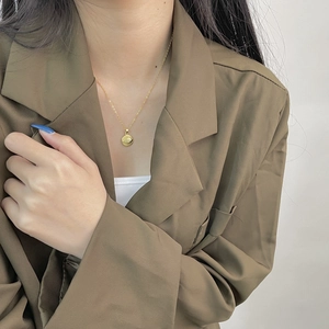Minimalist 925 sterling silver evil eye pendant necklace worn on a gold chain