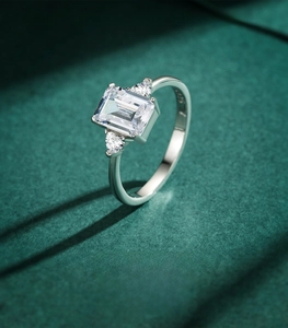 Macro shot of 925 sterling silver ring with emerald-cut zircon and triangular side stones