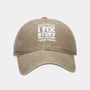Detail of khaki washed cotton baseball cap featuring I FIX STUFF white printed text