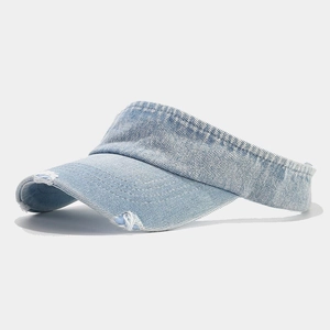 Close-up of distressed denim sun visor with ripped brim and twill texture details