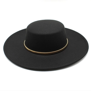 Detail view of black wool felt boater hat featuring a stylish gold spring band accessory