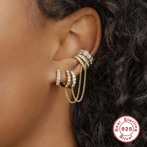 Detail of S925 sterling silver gold ear cuff set with tassel chains and white zircons