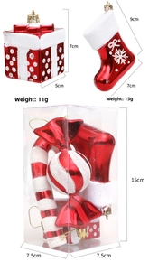 Detail view of red and white Christmas ornament set with glitter snow in PVC box